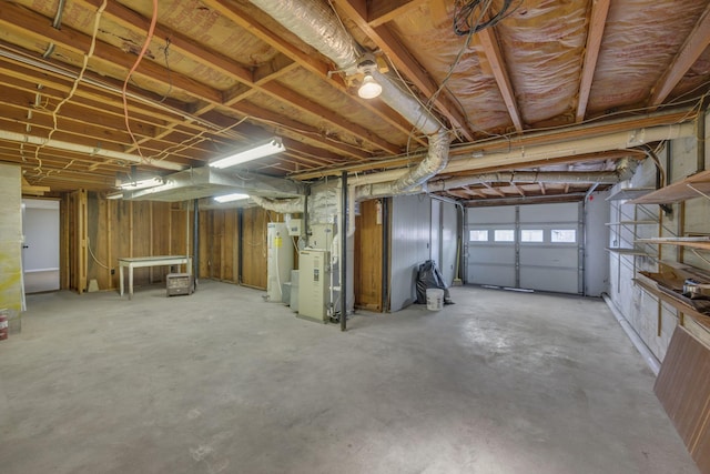 garage featuring water heater and heating unit