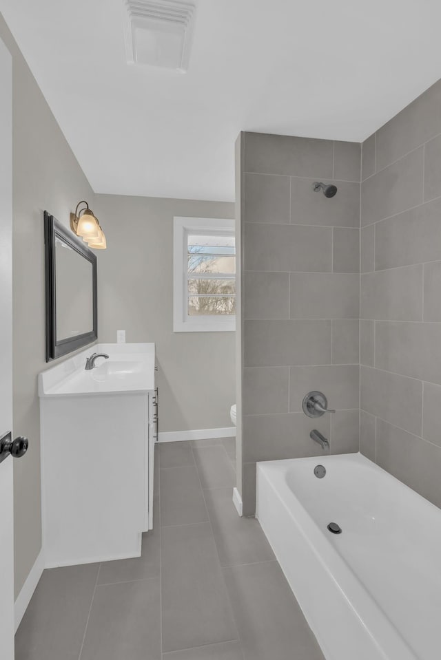 full bathroom with bathtub / shower combination, visible vents, vanity, baseboards, and tile patterned floors