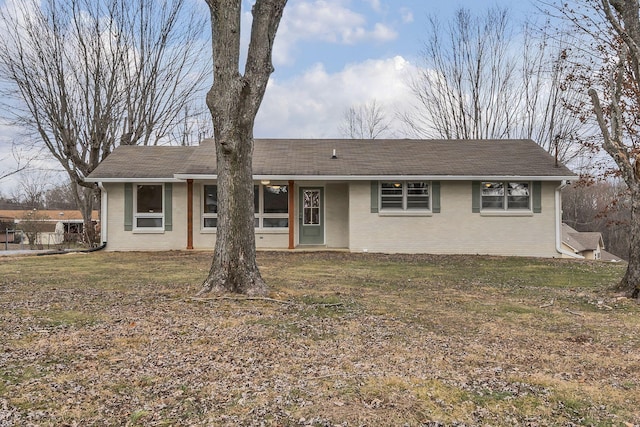 single story home featuring a front yard and brick siding