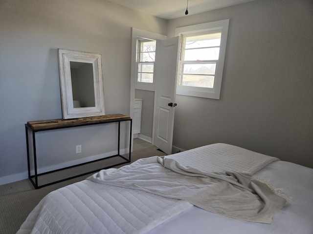 carpeted bedroom featuring baseboards