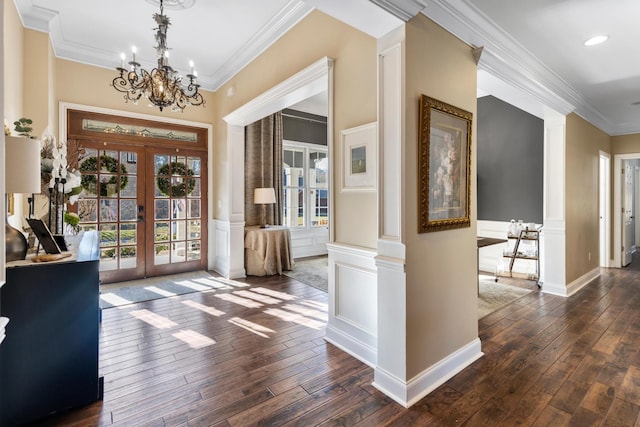 interior space featuring dark hardwood / wood-style flooring, crown molding, french doors, and an inviting chandelier