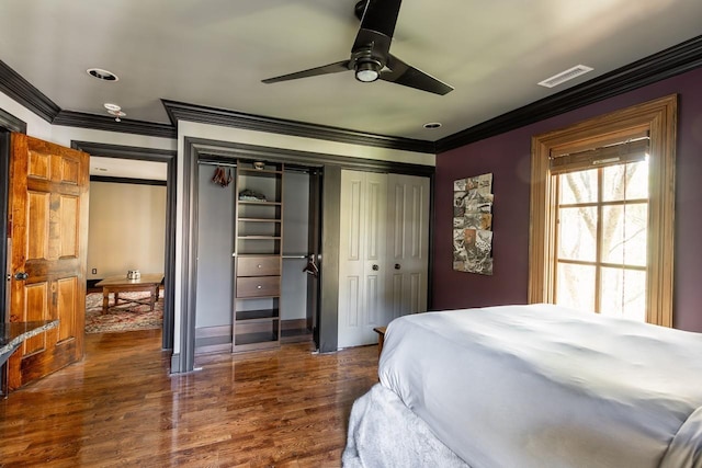 bedroom with dark hardwood / wood-style flooring, ornamental molding, and ceiling fan