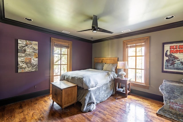 bedroom with wood-type flooring, ornamental molding, and ceiling fan