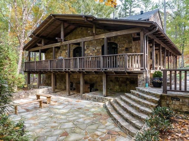 rear view of house with a patio, a sunroom, and a wooden deck