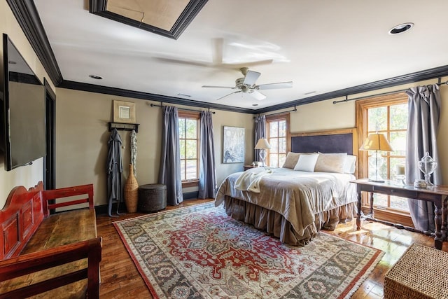 bedroom featuring ceiling fan, ornamental molding, and dark hardwood / wood-style flooring