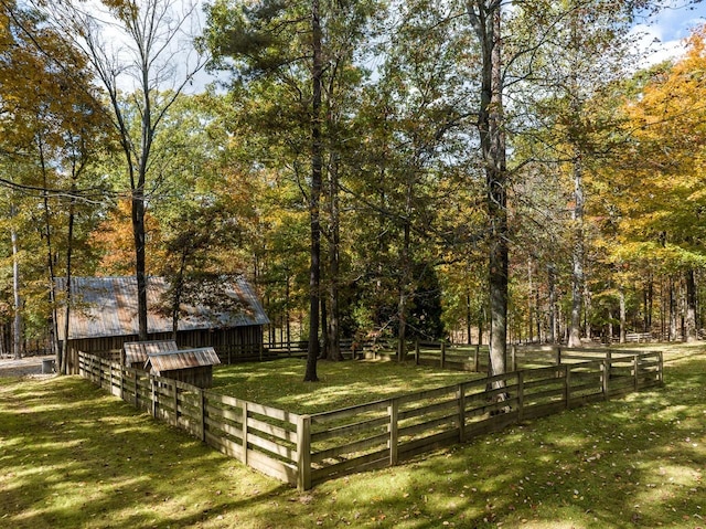 view of property's community with an outdoor structure and a yard