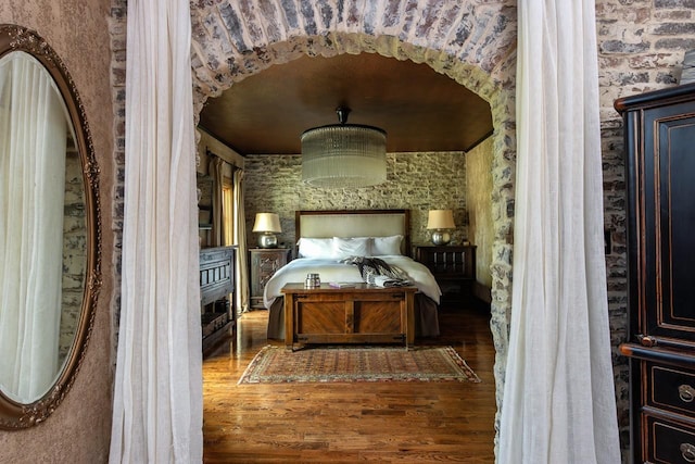 bedroom with dark hardwood / wood-style floors