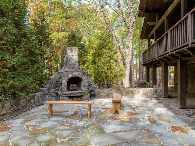 view of patio / terrace featuring an outdoor stone fireplace