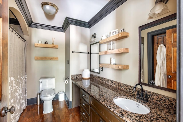 bathroom featuring hardwood / wood-style flooring, ornamental molding, toilet, and vanity