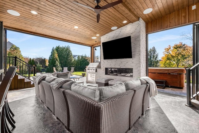 view of patio / terrace with an outdoor living space with a fireplace, ceiling fan, a grill, and a hot tub