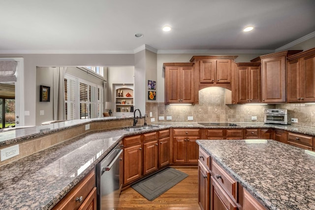 kitchen featuring stainless steel dishwasher, black electric cooktop, brown cabinets, and a sink