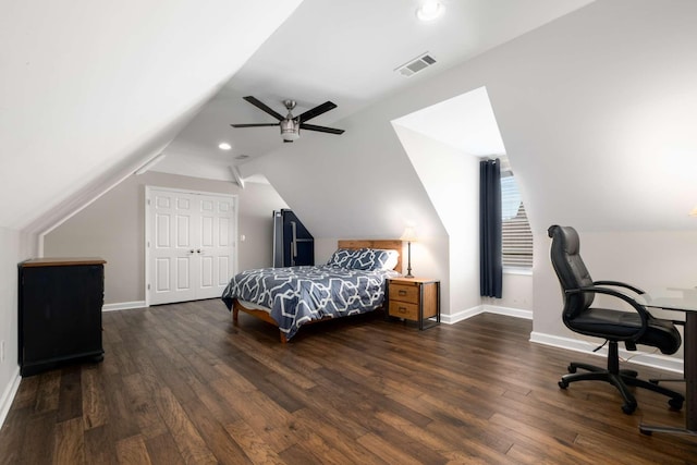 bedroom featuring ceiling fan, dark hardwood / wood-style floors, vaulted ceiling, and a closet