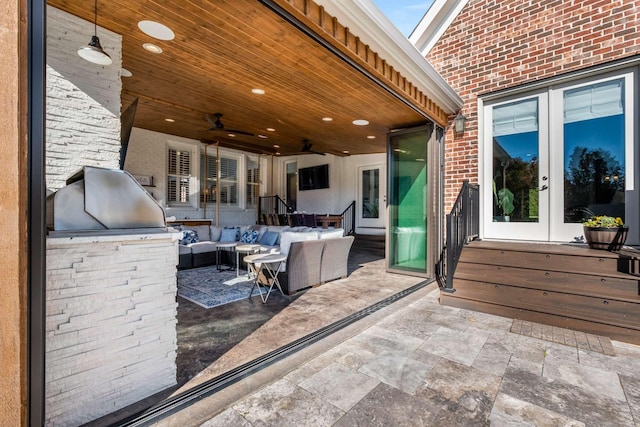 view of patio featuring a ceiling fan, an outdoor living space, area for grilling, and french doors