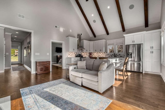 living room featuring dark hardwood / wood-style flooring, high vaulted ceiling, and beamed ceiling