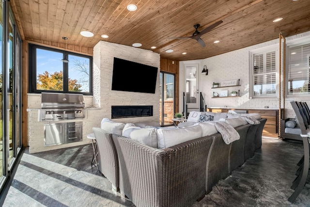 living area with a ceiling fan, finished concrete floors, recessed lighting, wooden ceiling, and a fireplace