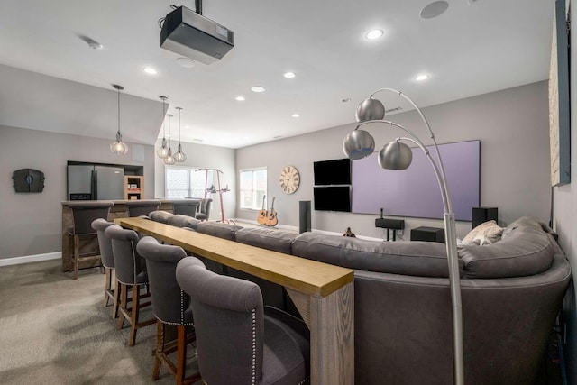 living area with carpet flooring, recessed lighting, baseboards, and bar