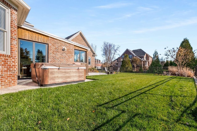 view of yard with fence and a hot tub