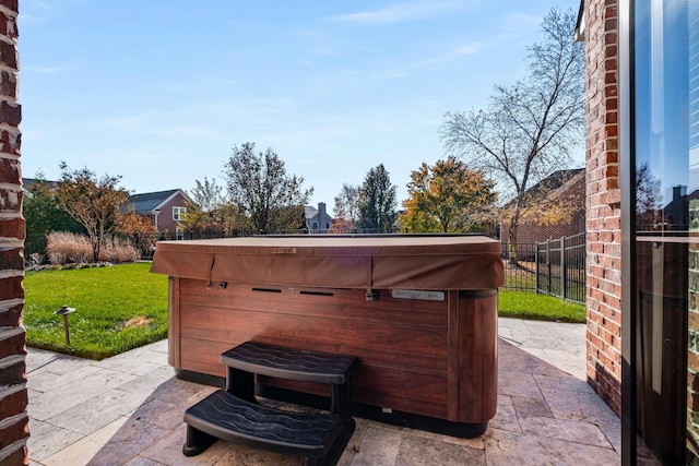 view of patio / terrace with fence and a hot tub