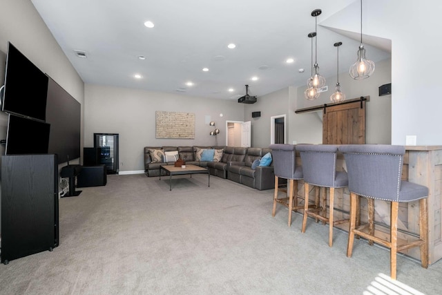 living room featuring visible vents, baseboards, light colored carpet, a barn door, and recessed lighting