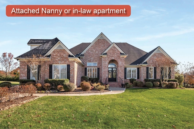 view of front of property featuring a front yard and brick siding