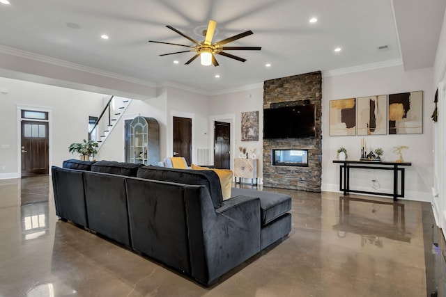 living room featuring concrete flooring, ornamental molding, ceiling fan, and a fireplace