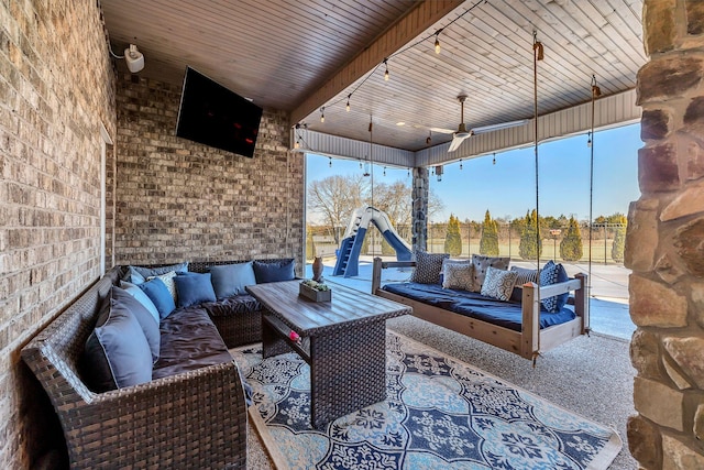 view of patio featuring a playground, outdoor lounge area, and ceiling fan