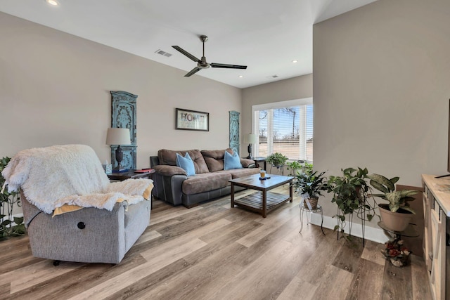 living room with ceiling fan and light hardwood / wood-style flooring