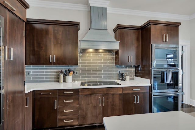 kitchen featuring premium range hood, dark brown cabinets, appliances with stainless steel finishes, ornamental molding, and decorative backsplash