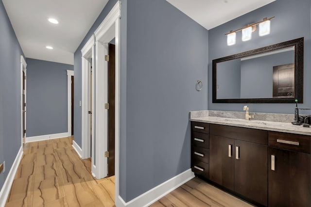 bathroom featuring wood-type flooring and vanity