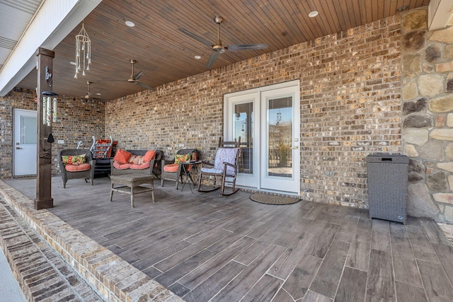 wooden terrace with ceiling fan and outdoor lounge area