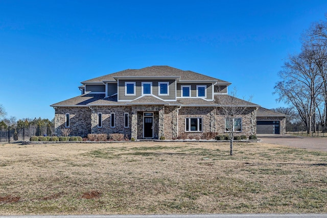 view of front of house featuring a garage and a front lawn