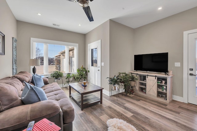 living room with hardwood / wood-style floors and ceiling fan