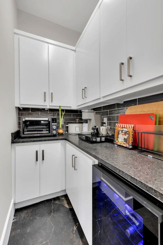 kitchen with wine cooler, backsplash, and white cabinets