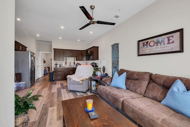 living room with ceiling fan and light wood-type flooring