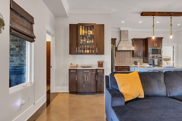 kitchen featuring pendant lighting, premium range hood, appliances with stainless steel finishes, backsplash, and ornamental molding