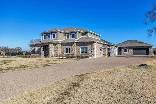 view of front of house featuring a garage and a front yard