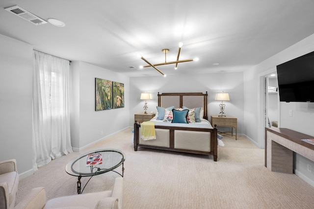 carpeted bedroom featuring an inviting chandelier