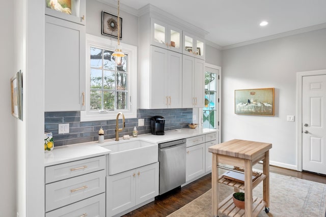 kitchen with decorative light fixtures, white cabinetry, dishwasher, sink, and ornamental molding