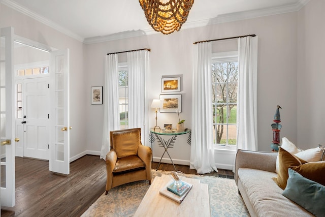 living area with ornamental molding, a healthy amount of sunlight, and dark hardwood / wood-style floors