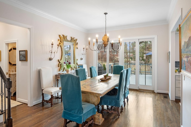 dining area with ornamental molding, dark hardwood / wood-style floors, and a chandelier