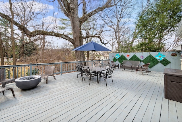 deck featuring an outdoor living space with a fire pit