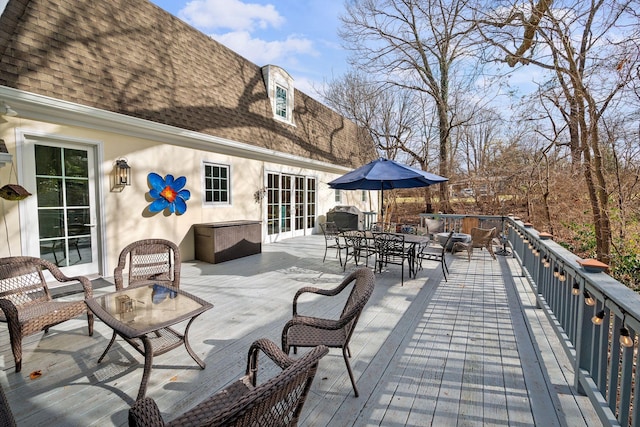 wooden deck with an outdoor living space and a grill