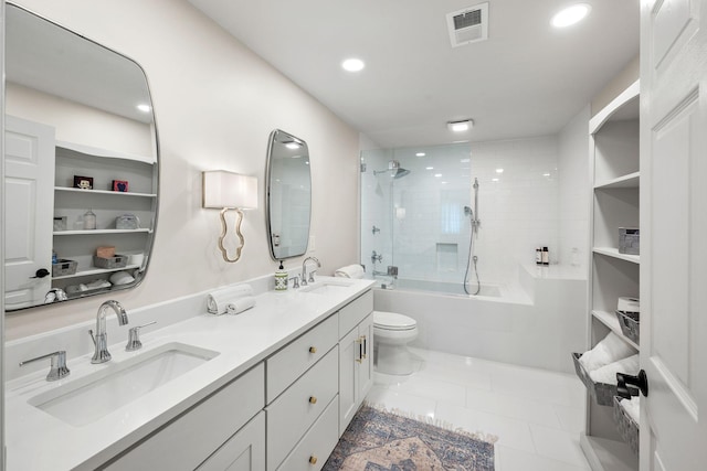 full bathroom featuring vanity, tile patterned flooring, toilet, and tiled shower / bath