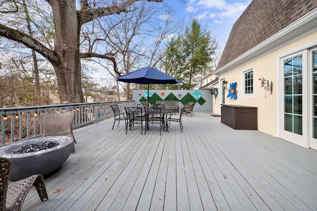 wooden terrace with a fire pit