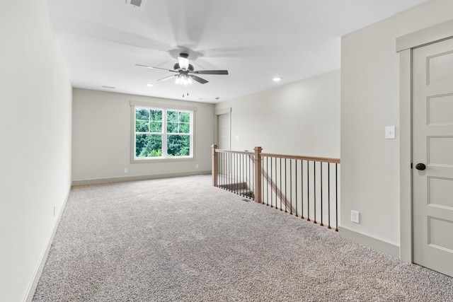 spare room with ceiling fan and carpet floors