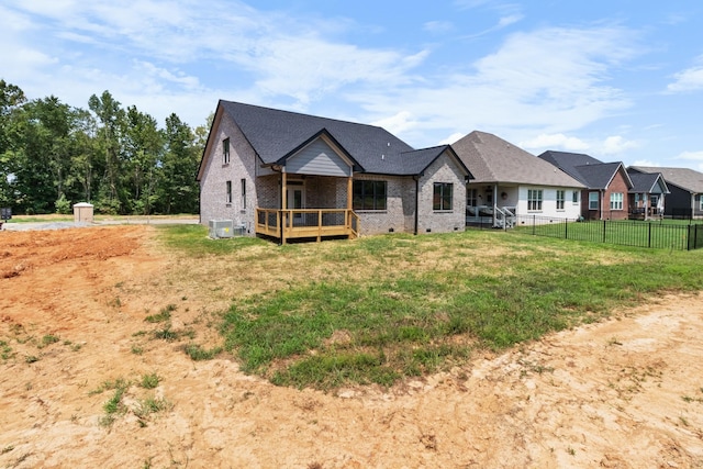 rear view of house with a yard