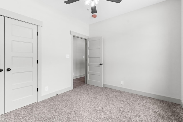 unfurnished bedroom with ceiling fan, a closet, and carpet