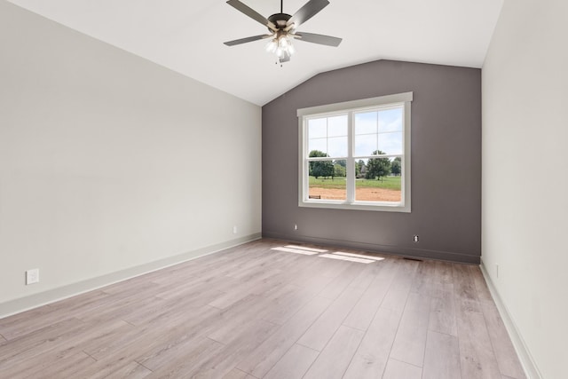 spare room featuring vaulted ceiling, ceiling fan, and light hardwood / wood-style flooring