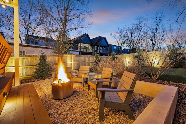 patio terrace at dusk featuring an outdoor fire pit