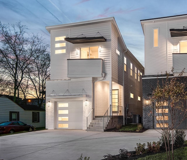 contemporary home featuring a garage and central AC